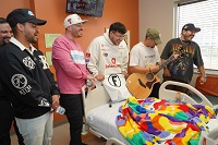 Members of Grupo Frontera performing for children at the hospital