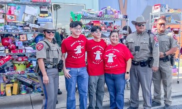 Isaac Garza and family posting with donation collection