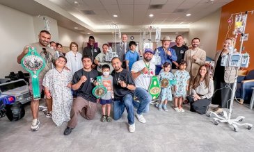 RGV Boxers posing with STHS Children's patients holding their championship belts. 