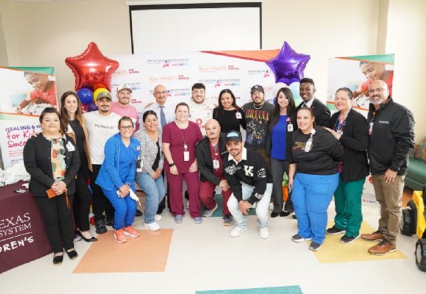 Grupo Frontera band posing with STHS Children's staff 