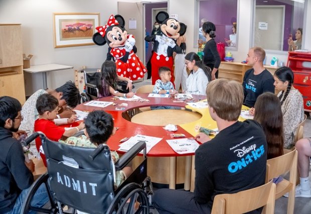 Mickey, Minnie, and Disney on Ice staff visiting STHS Children's patients