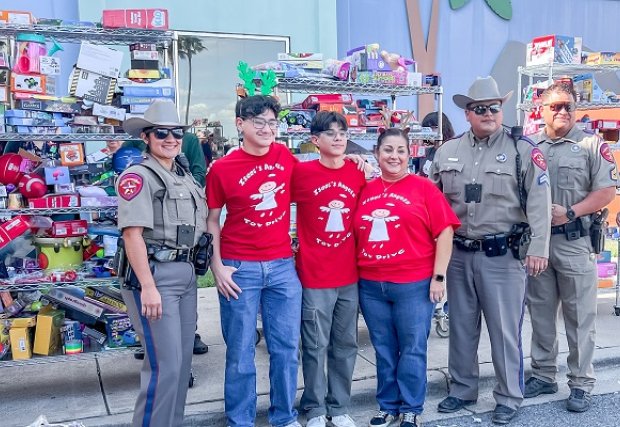 Isaac Garza and family posting with donation collection
