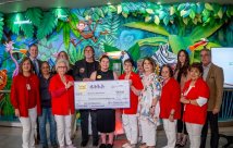 Spirit Halloween and STHS Children's staff holding donation check