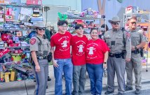 Isaac Garza and family posting with donation collection