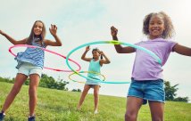 young girls hula hooping in a park